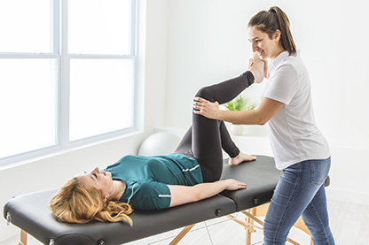 Photo of female physical therapist working with a female patient