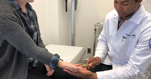 Dr. Osei examining a patient.