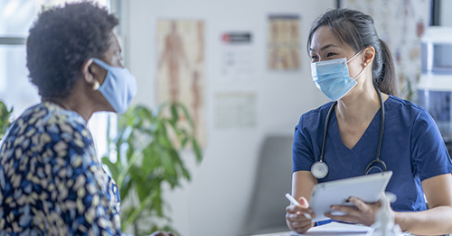 A clinician meeting with a patient.
