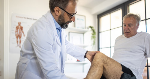 Physician knee exam.
