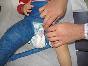 Tucking small diaper inside front.