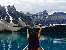 HSS patient kayaking on a mountain lake