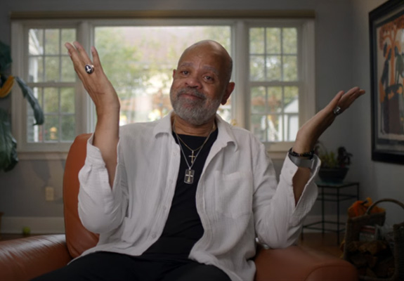 Jerome raising his hands with joy.