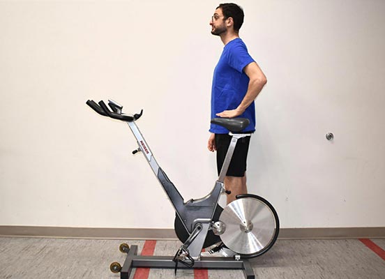 man on exercise bike demonstrating seat height position